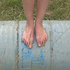 Danielle Rolling Over Grass