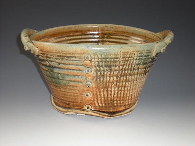 Oval pottery with nails and handles