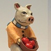 Clay pig on  flowered ottoman.