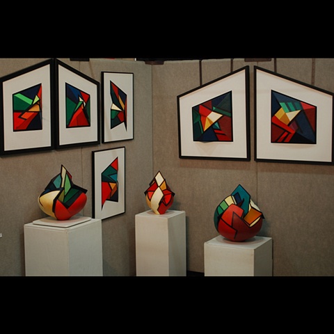 Partial booth photo of work by Terry Habeger.  Pieces are fired clay, handpainted with acrylics.