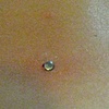 Two fresh dermal anchors on the lower back.
