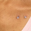 healed surface piercing on the chest.  freshly changed from 14 gauge disc backs to 14 gauge flat cz's