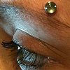 two month(ish) old surface anchor above the eyebrow.  Freshly changed to a stone.