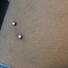 Two very healed surface piercings on the hips with Cz's.