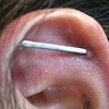 This is a very healed Illusional.  The Illusional is the name for this piercing that I am pretty sure I invented.  A surface barbell is used to create the illusion of the Industrial piercing.  