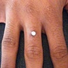 Super healed dermal anchor on the finger.  Freshly changed to the bezel set cz.