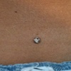 Three very healed dermal anchors on the lower back.  Cz in the middle and to be changed disc backs on the left and right side.