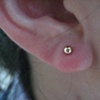 fresh earlobe piercing with gold stud (right ear)