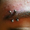 One really old( a year +) eyebrow piercing on the left, and the very fresh one on the right.