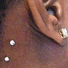 Two fresh dermal anchors on the neck/behind  the ear with cz's