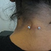 healed nape piercing with freshly changed prong set cz's (zoomed out view)