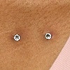 slight zoom in on the same chest surface piercing.