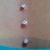 three healed dermal anchors on the chest with freshly changed prong set cz's