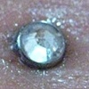 Fresh Dermal anchor on the middle of the low back. (zoomed in view)