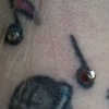 Three very healed 18g dermal anchors on the nape