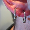 Two fresh earlobe piercings for an orbital