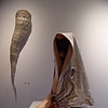 On the pedestal is Jym Paris' wearable piece with Samantha Brown's wall sculpture behind. 
