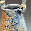 Soda fired vase with basket handle
