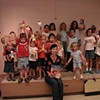 Rene and the kids with their beautiful paper dolls at the end of a fun library visit.