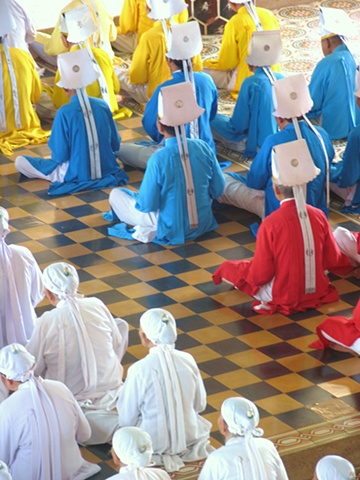 The male elders of the Cao Dai wear diferent colors to represent  the many religious aspects in Cao Dai.  Red is catholocism, yellow Buddhism and Blue for Hindi.