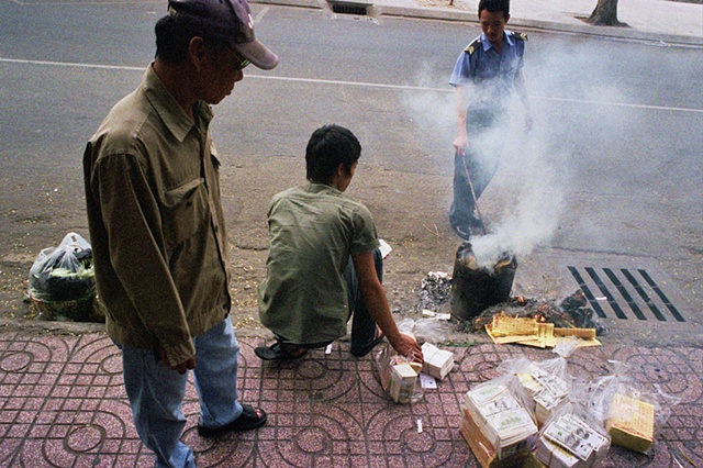 During Tet, burning fake money and shoving the ashes into the public drains for ancestors is a common occurrence in downtown Saigon.