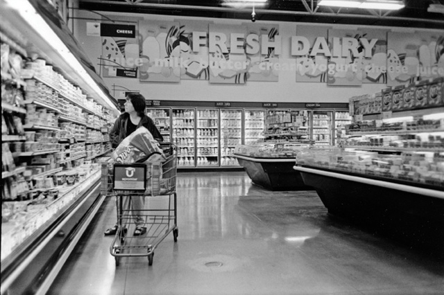 Maggie shops for her husband and family.  She is not partaking in anything in the cart.