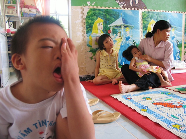 A bright morning at Thien Phuc Ophanage, highlights a caretaker and some of the children that call this place home.