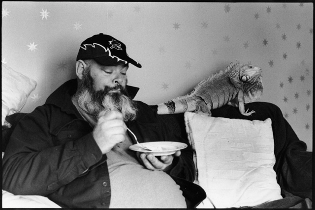 Bill eats cereal in his living room in Freeport, Maine, with his 25 year old iguana, Mogwana.