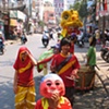 Children perform the "Kitchen Dance" in random homes in Saigon, banging the drum and scaring away the spirits for the coming year.