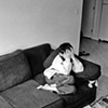 Faysel's son sits shyly on the couch the day before the big move to Portland from Lewiston, Maine.