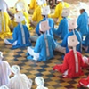The male elders of the Cao Dai wear diferent colors to represent  the many religious aspects in Cao Dai.  Red is catholocism, yellow Buddhism and Blue for Hindi.