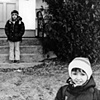 Faysel's sons wait for the bus outside of their house in Portland, Maine.