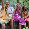 Pretty girls hanging out in a tree on a summers day.