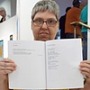 Michelle "Mimi" Miller reading her poetry and proudly displaying her poems in Starlight's first book of poems: Starlight's Genesis: An Anthology of the Starlight Gallery (edited by Katherine A. Loewen).

