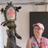 Mimi standing beside a Bill Stewart Sculpture at Indigo Gallery.
