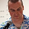 Left: Jeremy Garber reading poetry at the "Starlight's Genesis" poetry book launch on June.
