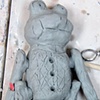 Frog doll sculpture (seen in previous photo) with arms and legs added.