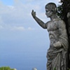Statue and Faraglioni rocks