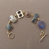 14kt gold, stones:  petersite, Leland blue, iolite, fossil coral, flower obsidian, sugelite in ricterite