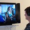 Gallery visitor viewing the interview with the last, living relatives of Hansel and Gretel.