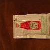 a packet of heinz ketchup that the artist opened emptied of its contents refilled with tomato seeds then sealed . its looks are like its never been touched.