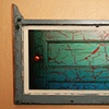 'behind the turquoise door' - behind antique-y window
