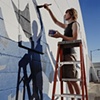 Thane Lund, Painting a mural he designed on the Crosby Sports Arena, Crosby, ND  2003