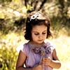 Girl with flower in field