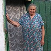 Olya in the doorway of her home