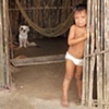 Child in doorway with dog
San Blas Islands