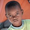 Haitian boy in new tent camp
L&eacute;og&acirc;ne
