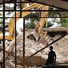 Watching his school being demolished
L&eacute;og&acirc;ne