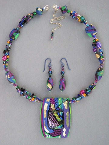 beaded polymer clay pendant featuring fused glass focal
