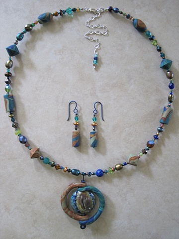 beaded necklace with polymer and lampwork glass pendant
